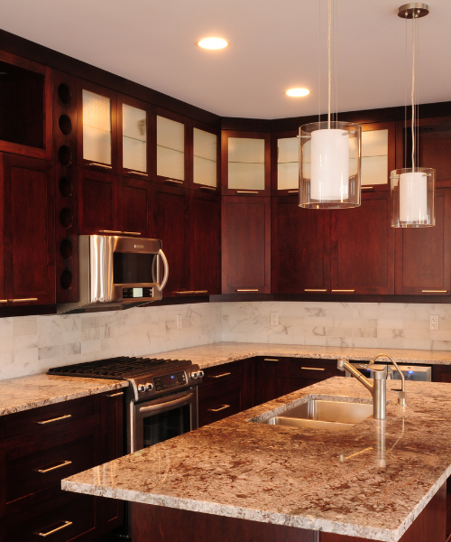 A kitchen with marble counter tops and wooden cabinets