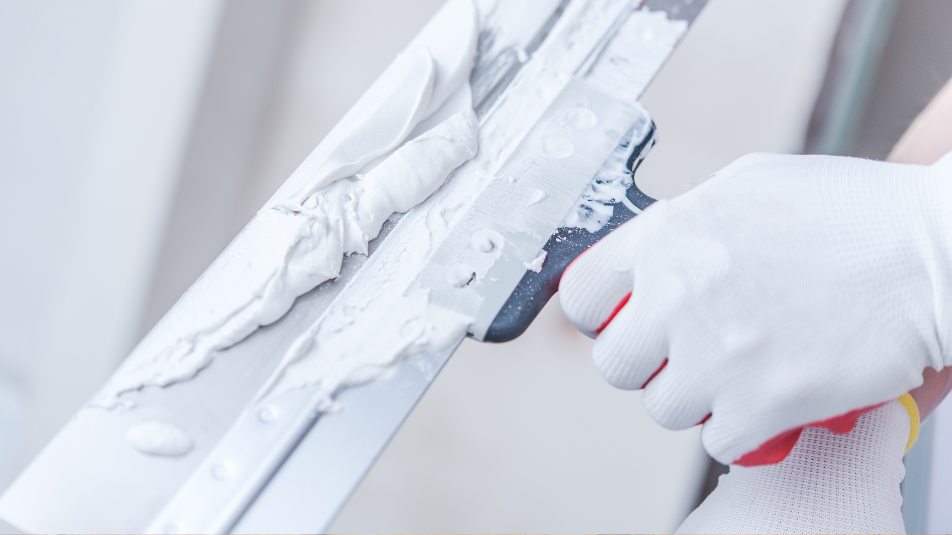 A person in white gloves holding a pair of scissors