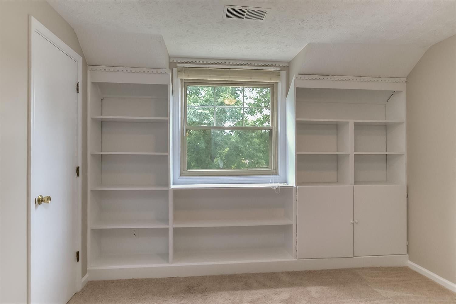 Freshly painted white built-in shelving around a bedroom window – Idylwild Drive, Richmond, KY